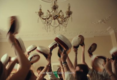 a group of people holding up hats in the air