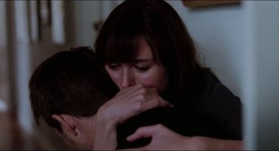 a man and a woman kissing in a room