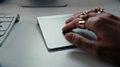 a person using a computer mouse on a desk