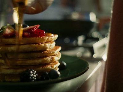 a stack of pancakes sitting on top of a green plate