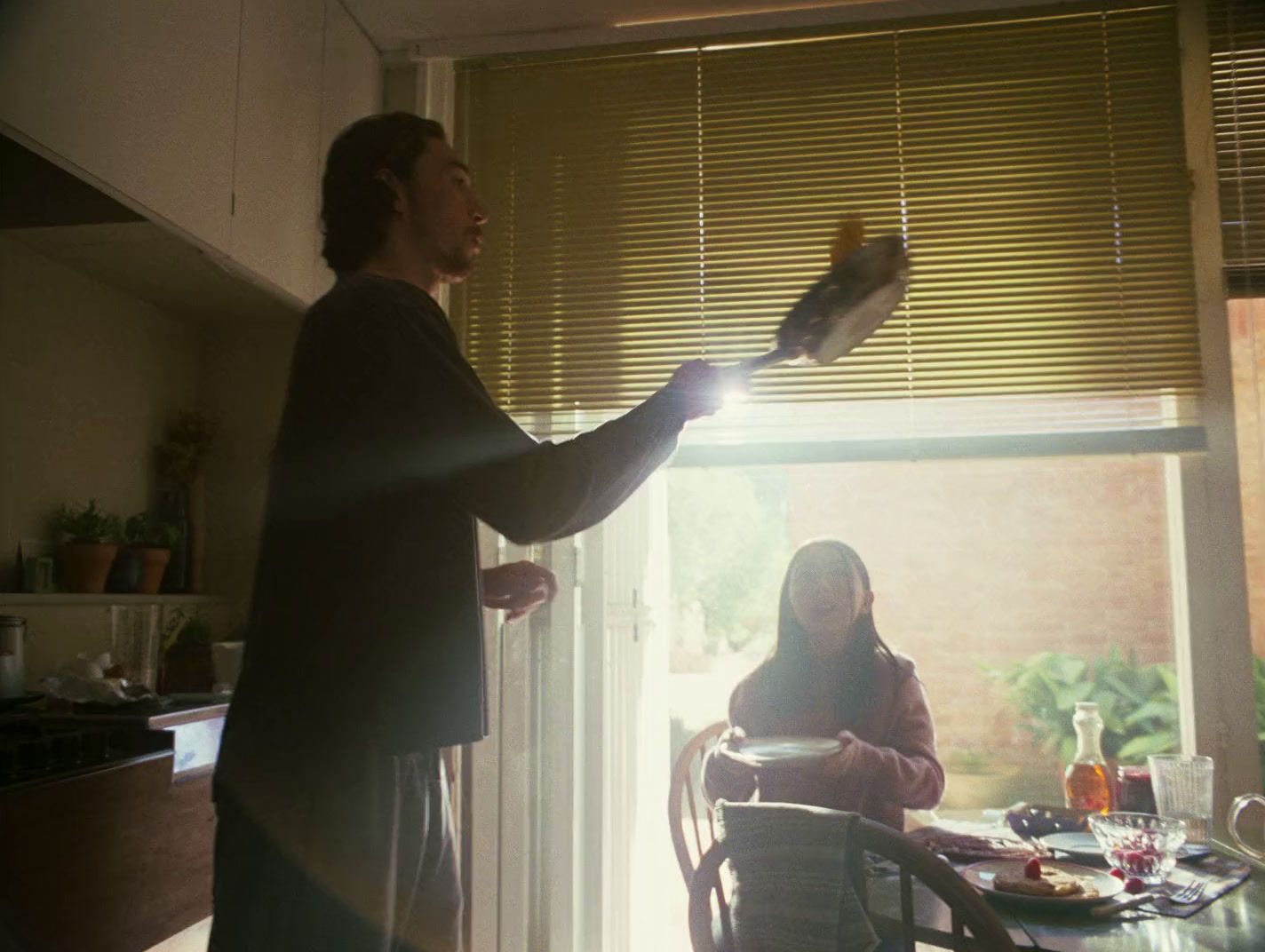 a man standing next to a woman in a kitchen