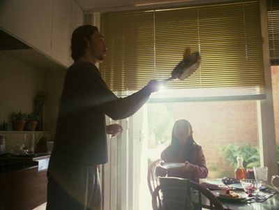 a man standing next to a woman in a kitchen