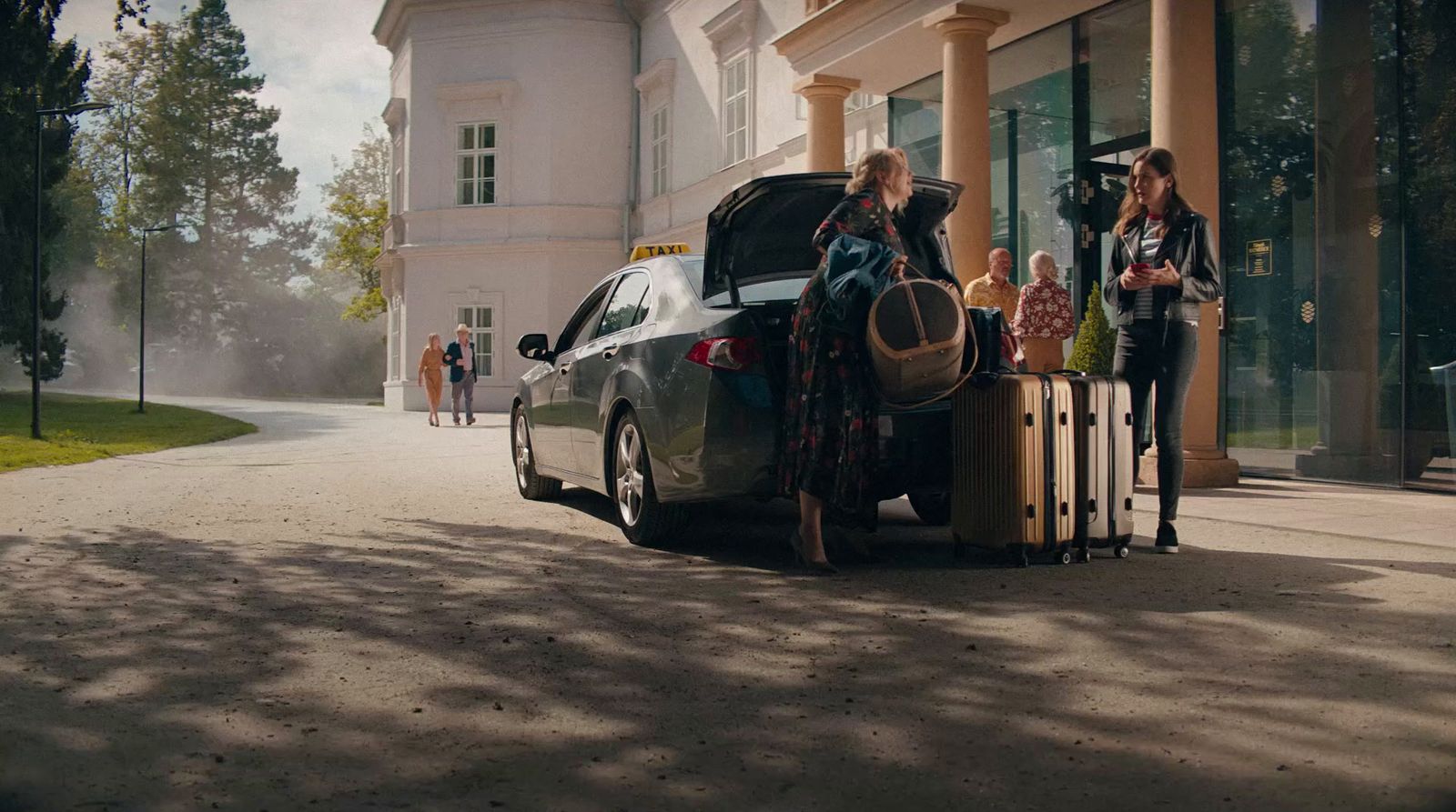 a group of people standing next to a car