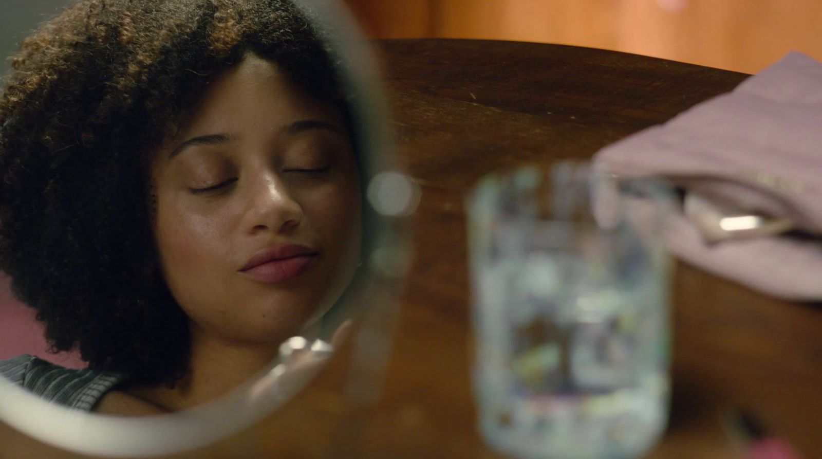 a woman looking at her reflection in a mirror