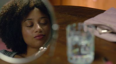 a woman looking at her reflection in a mirror
