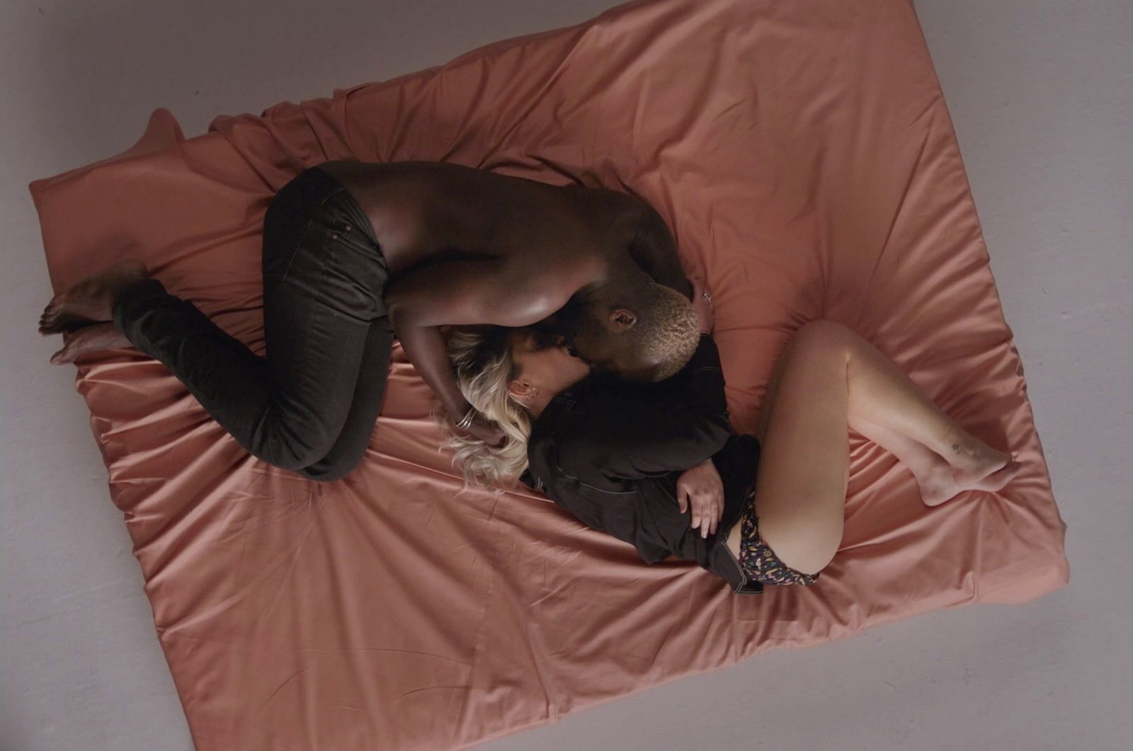 a man and a woman laying on a bed