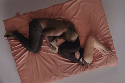 a man and a woman laying on a bed