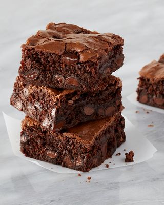 a stack of brownies sitting on top of a white plate