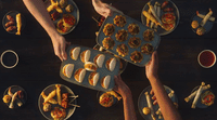 a group of people holding trays of food