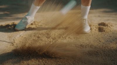 a person standing in the sand with a frisbee