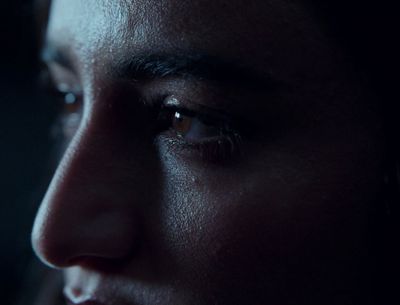 a close up of a person's face in the dark