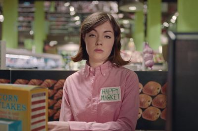 a woman with a happy market sign on her shirt