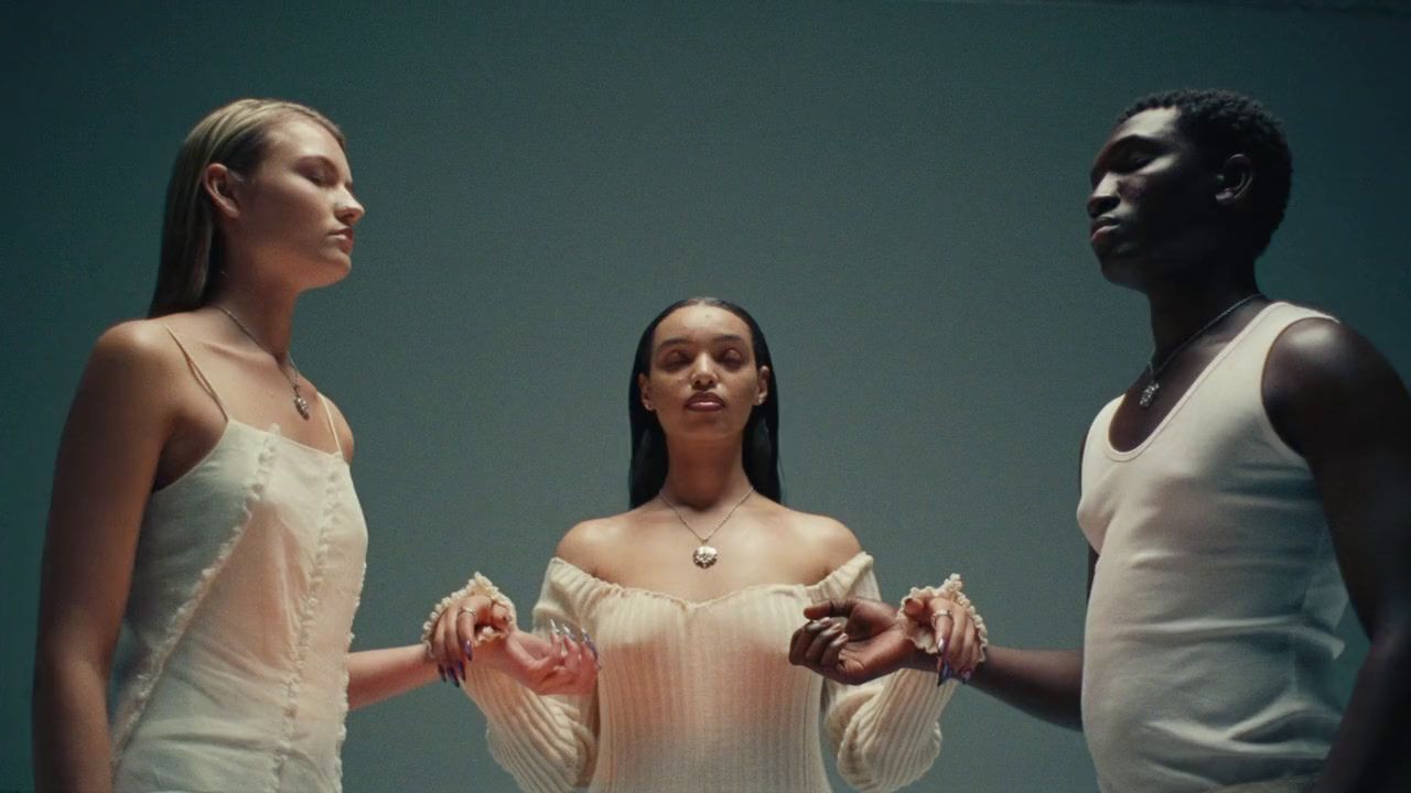 a group of three women standing next to each other