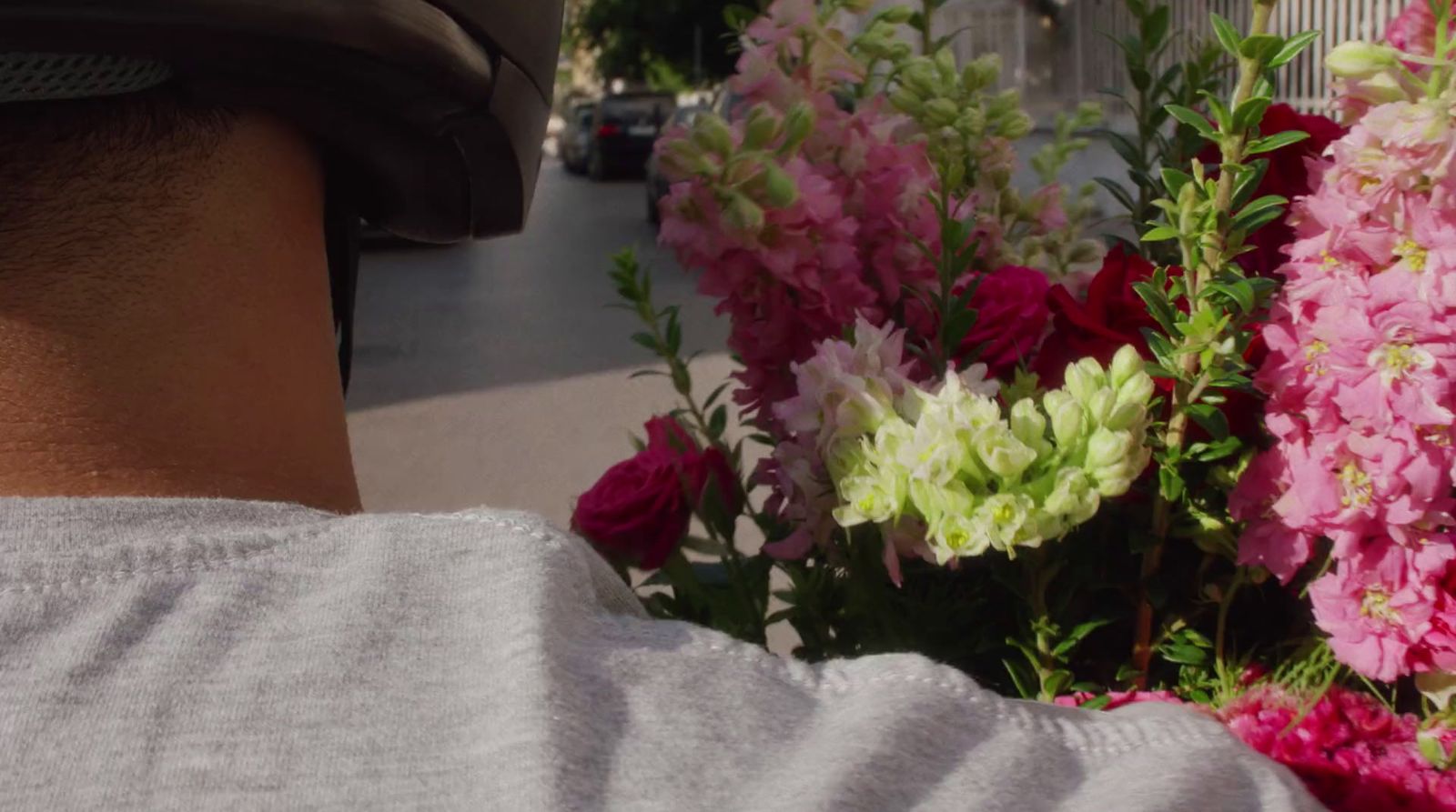 a man is looking at a bunch of flowers