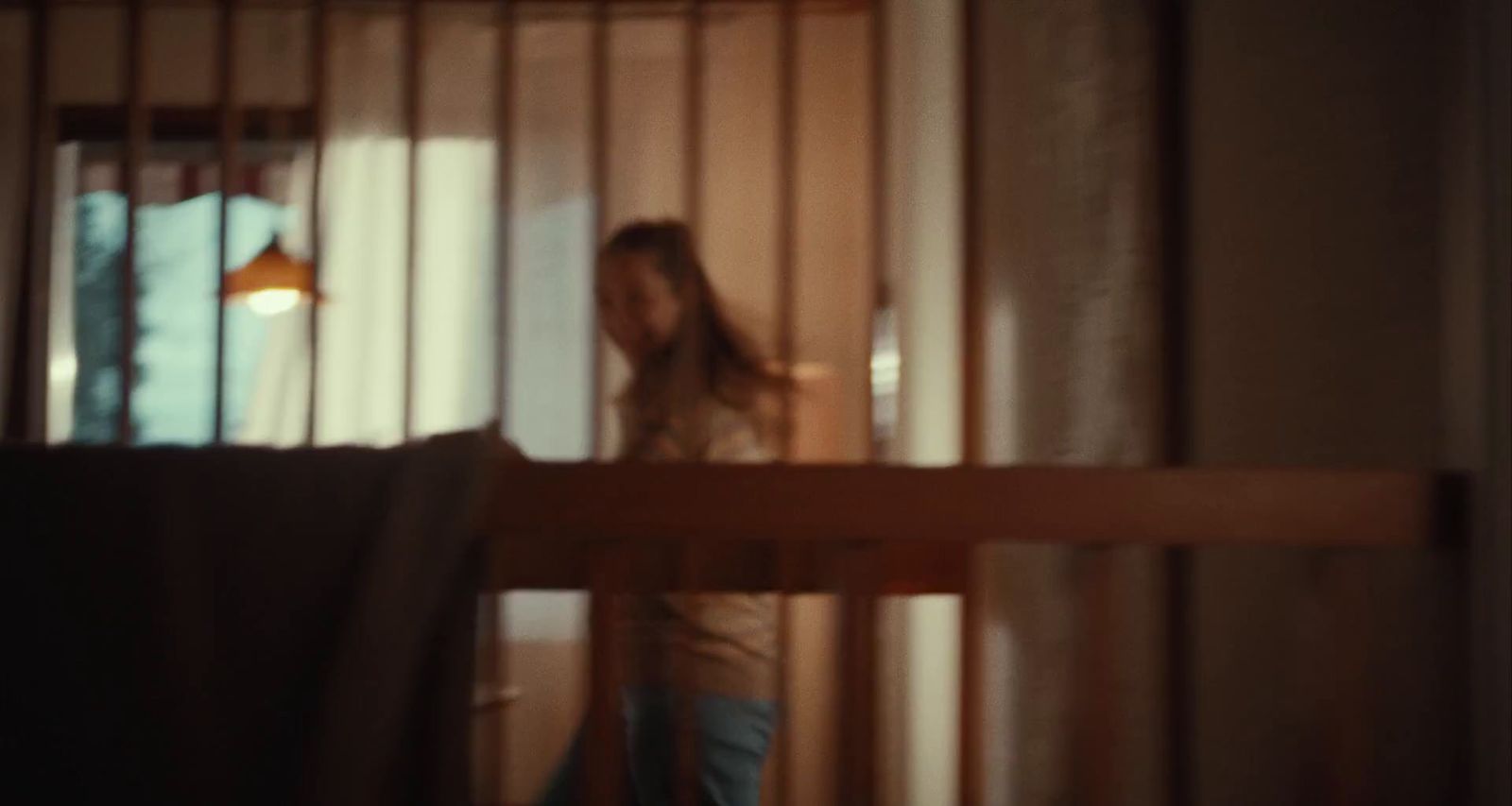 a woman standing in front of a window in a room