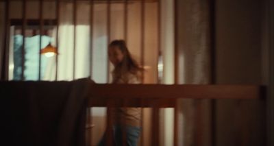 a woman standing in front of a window in a room