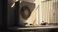 an air conditioner sitting on the side of a building