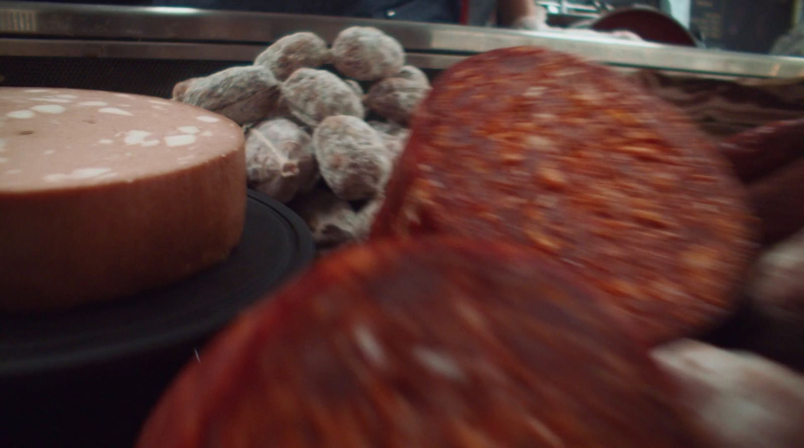 a chocolate cake sitting on top of a black plate