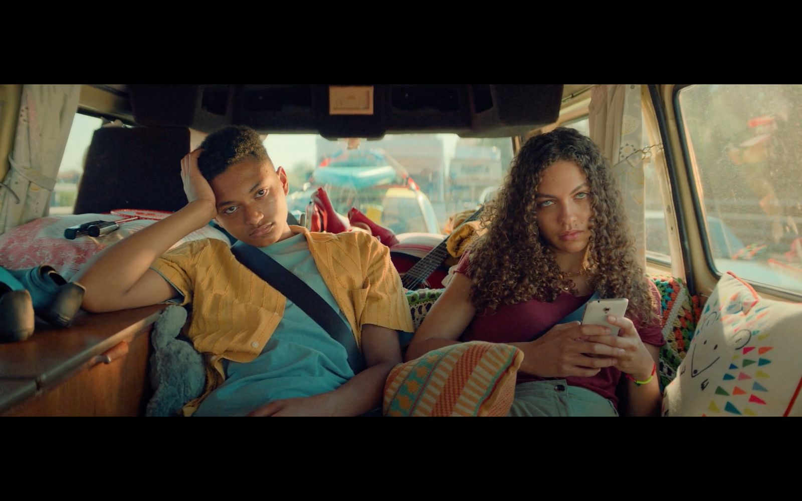 a man and a woman sitting in the back of a van