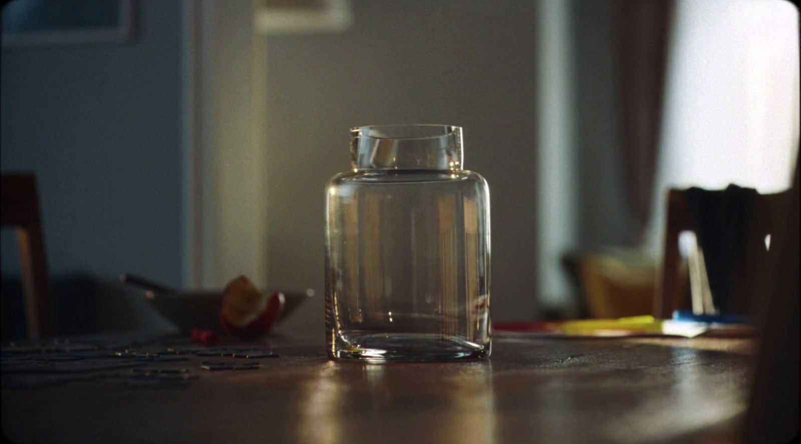 a glass vase sitting on a table in a room