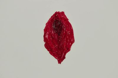 a red piece of yarn is hanging from a string