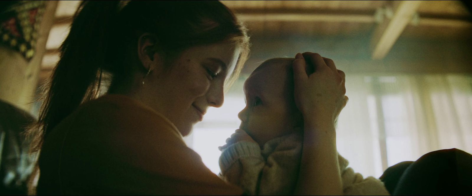 a woman holding a baby in her arms