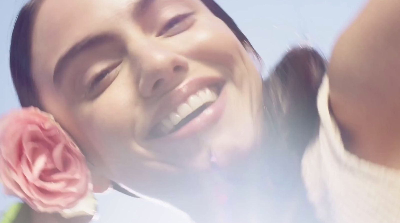 a close up of a person holding a flower