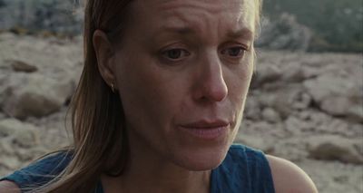 a close up of a woman with a concerned look on her face