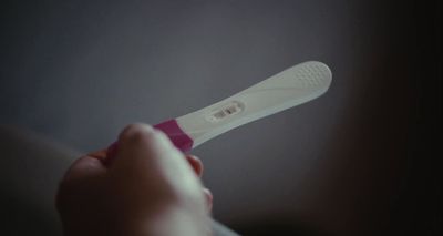 a close up of a person holding a toothbrush