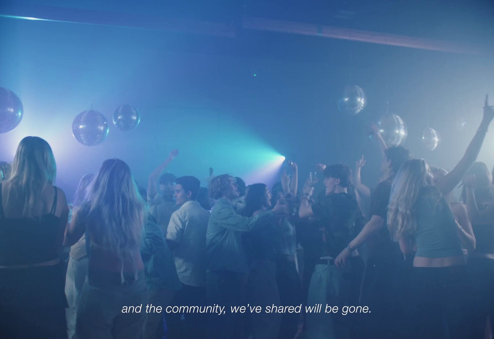 a group of people standing around each other in a room