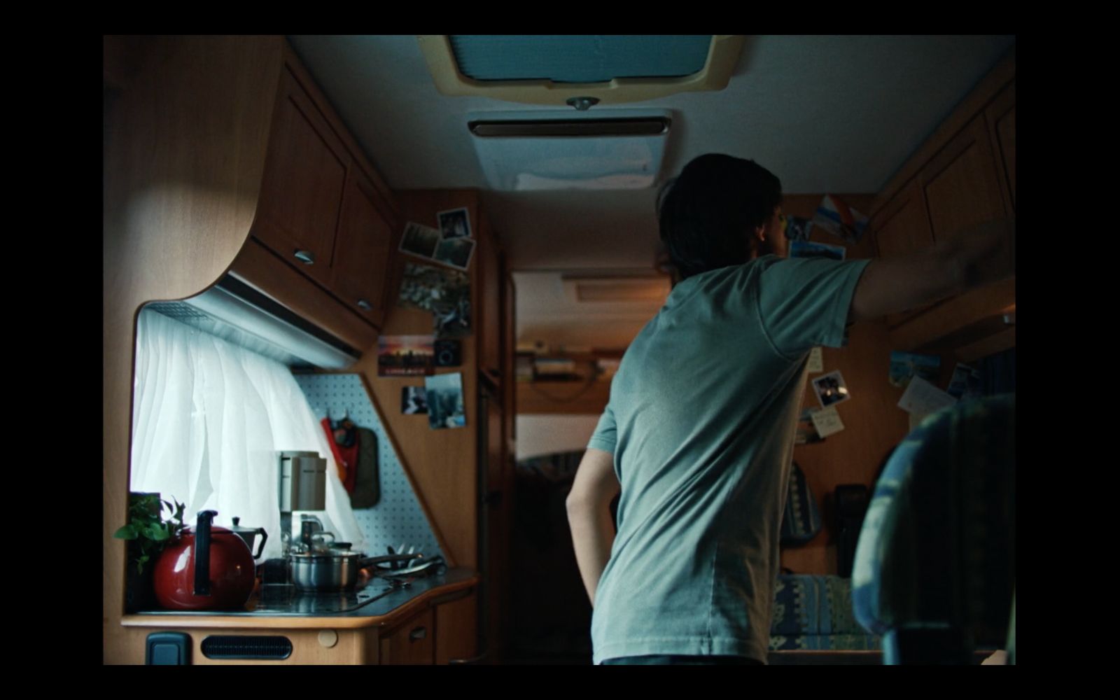 a man standing in a kitchen next to a stove top oven