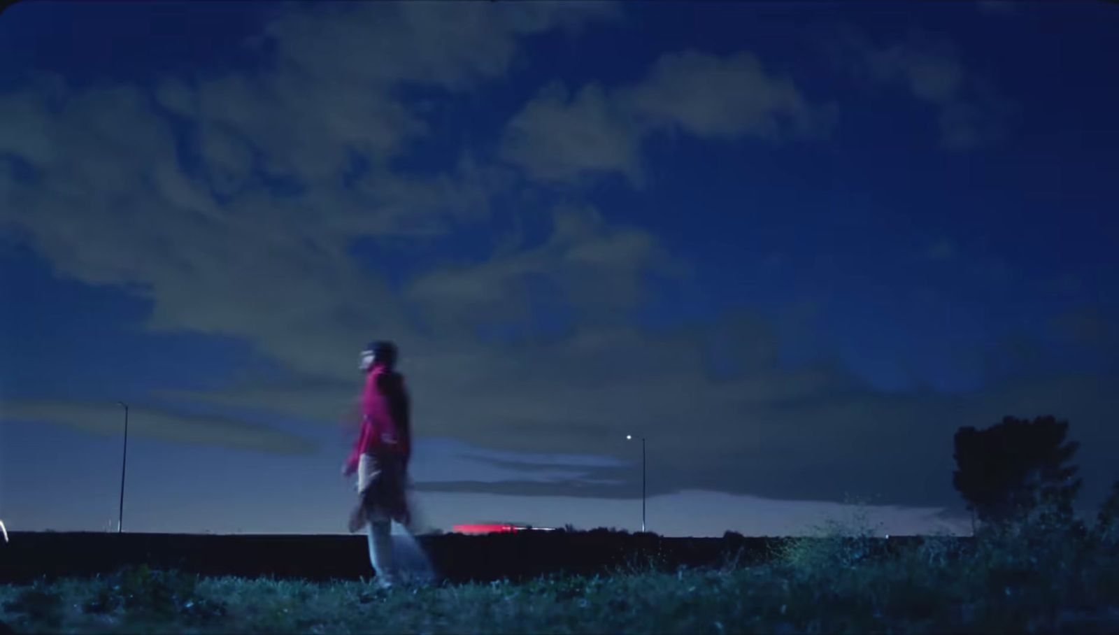 a man standing on top of a lush green field