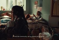 a group of people sitting on a bed in a room