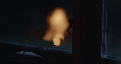 a blurry image of a person in a dark room