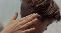 a person with their hand on their ear