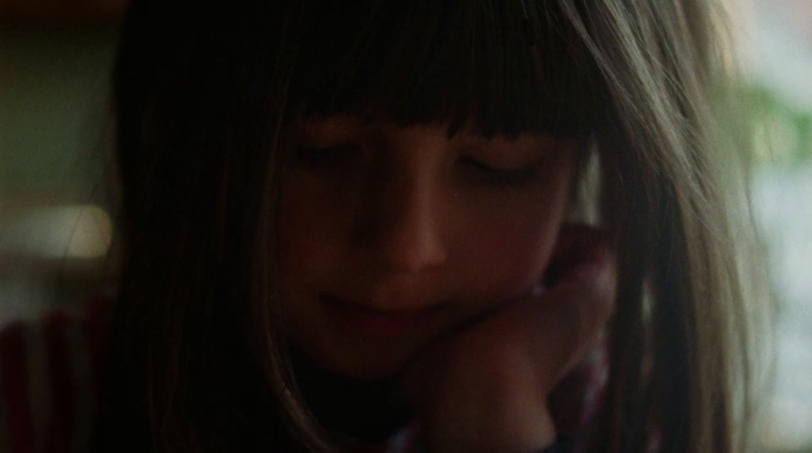 a close up of a person talking on a cell phone