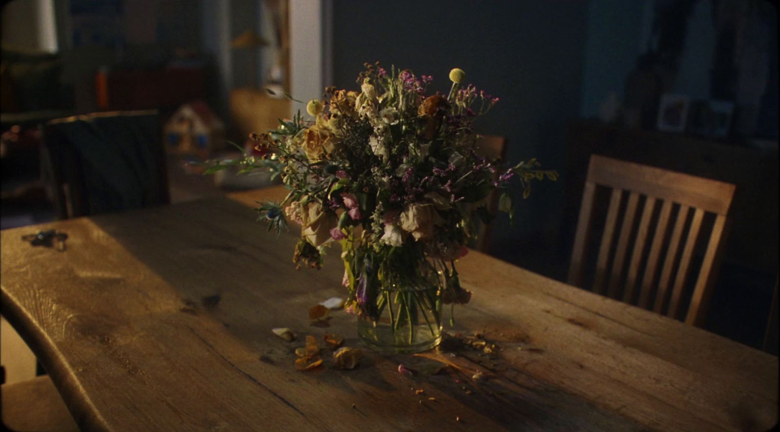 a wooden table topped with a vase filled with flowers