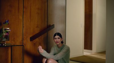 a woman sitting on the floor in a room