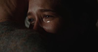 a close up of a person with a tear on their face