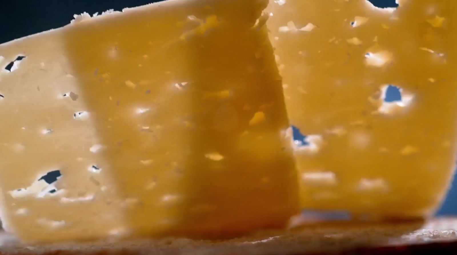 a couple of pieces of cheese sitting on top of a table