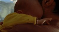 a man holding a baby in his arms