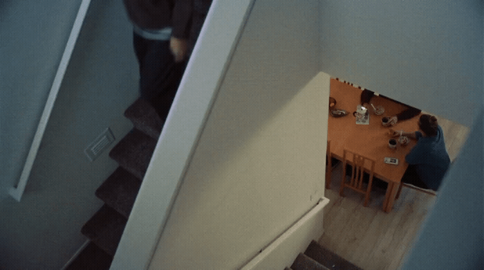 a man standing at the top of a stair case