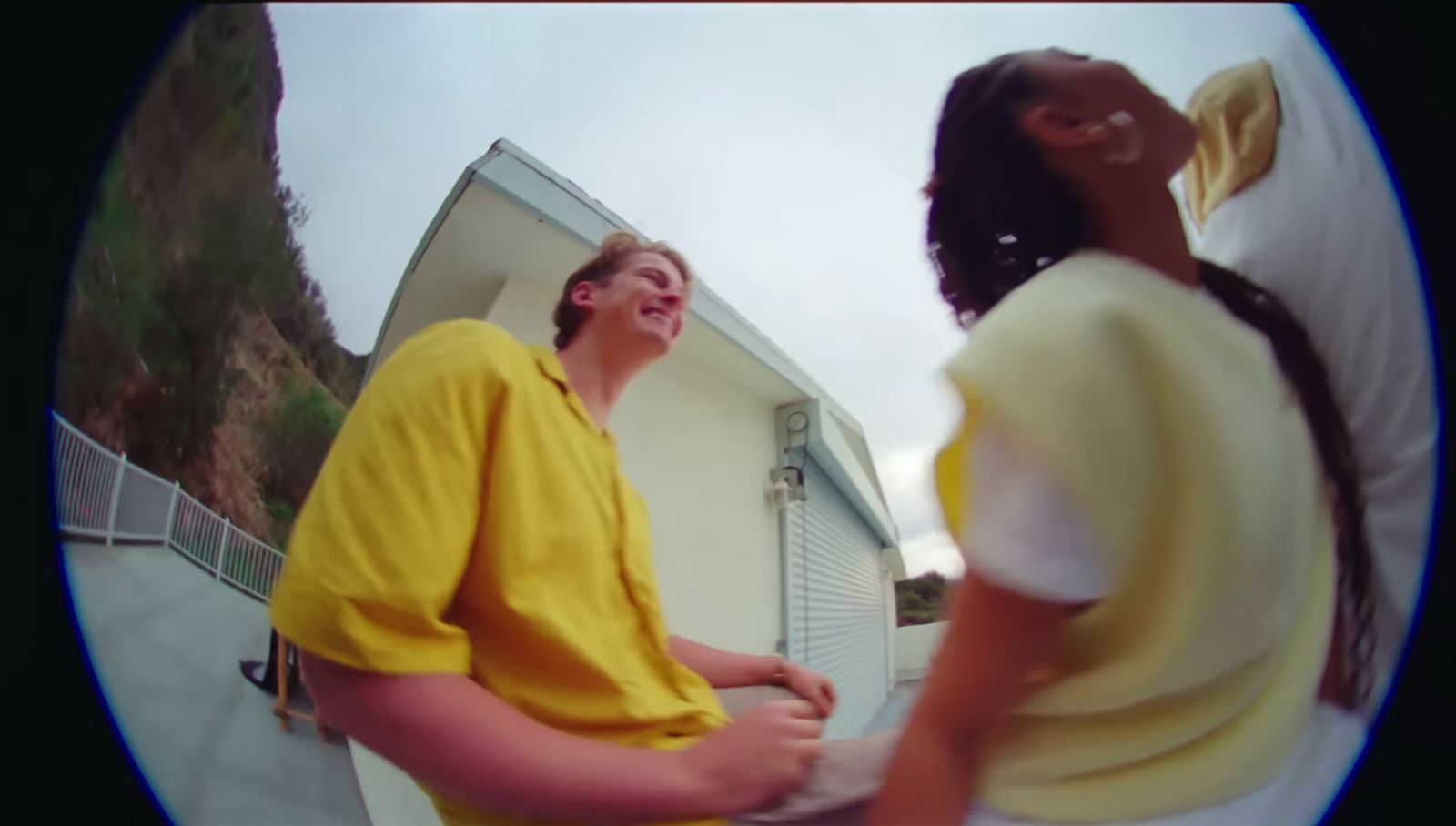 a man in a yellow shirt standing next to a woman