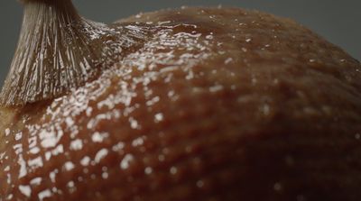 a close up of a piece of fruit with a plastic bag on top of it