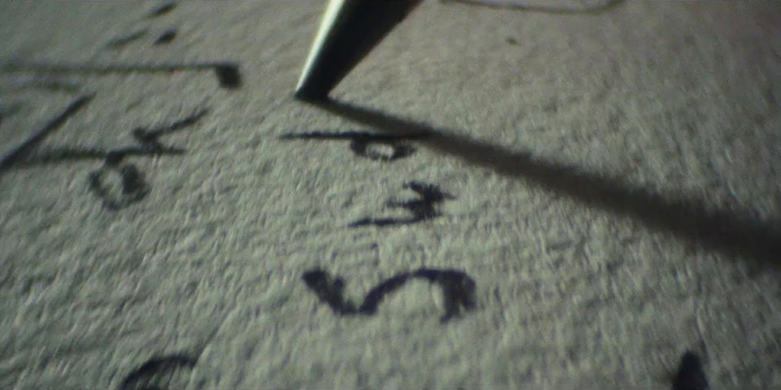 a close up of a person writing on the ground