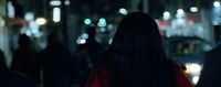 a blurry photo of people walking down a street at night