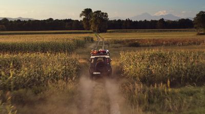 a four - wheeler driving through a field of tall grass