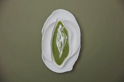 a white plate topped with a green sauce