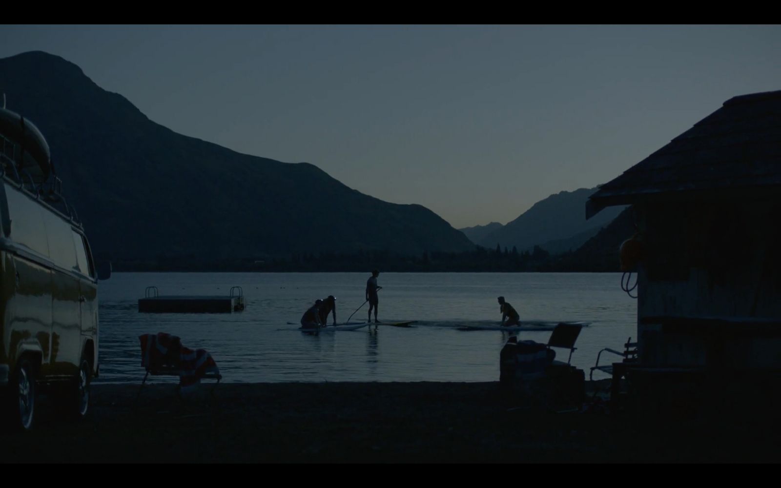 a group of people standing on top of a body of water