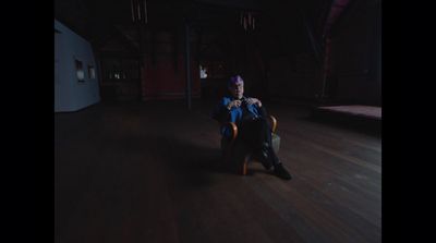 a man sitting in a chair in a dark room